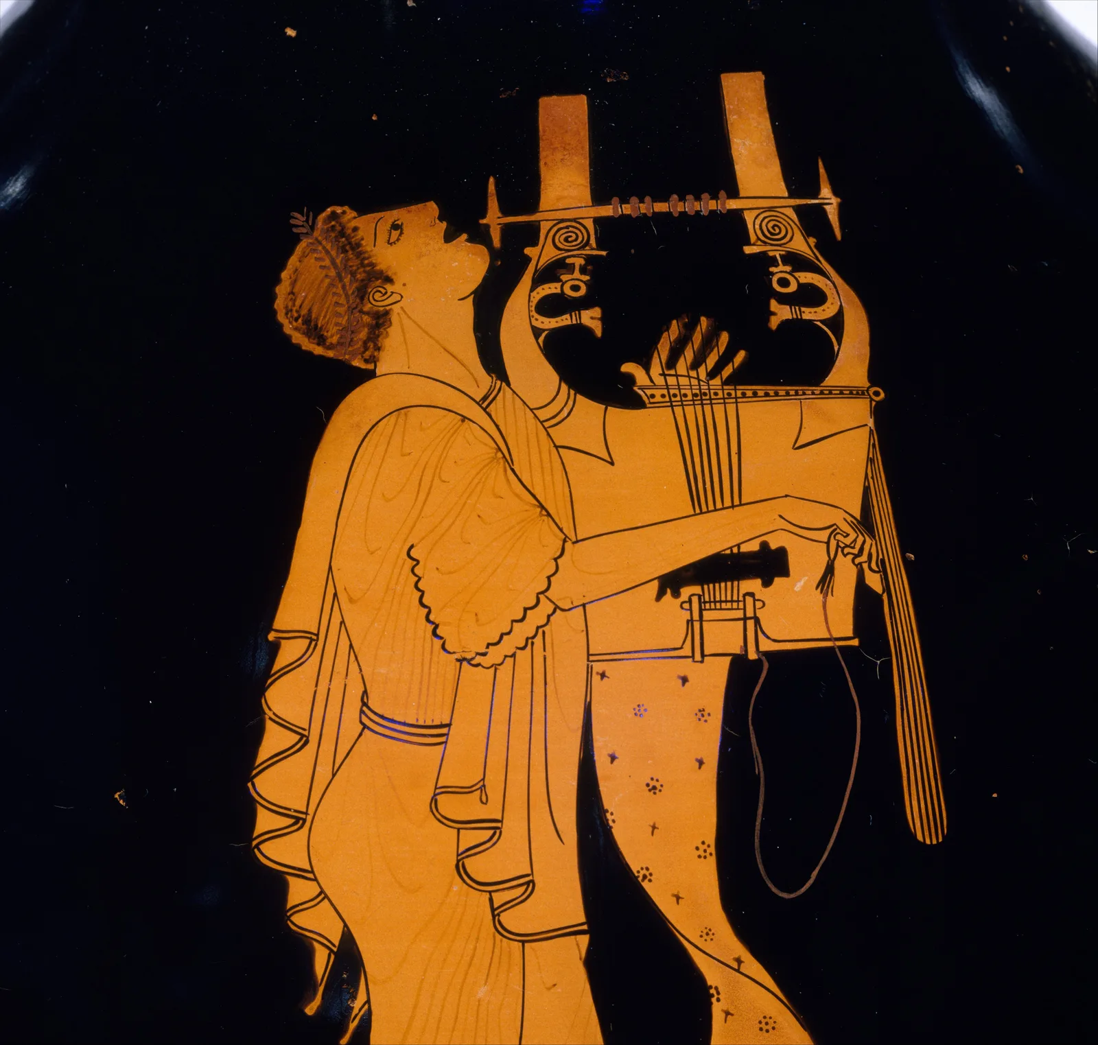 A young kitharode in a long robe, head thrown back in song, playing a seven-string kithara; red-figure on black